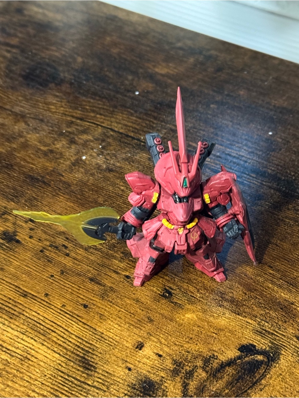Red Mecha Figure with Yellow Accents and Translucent Blade